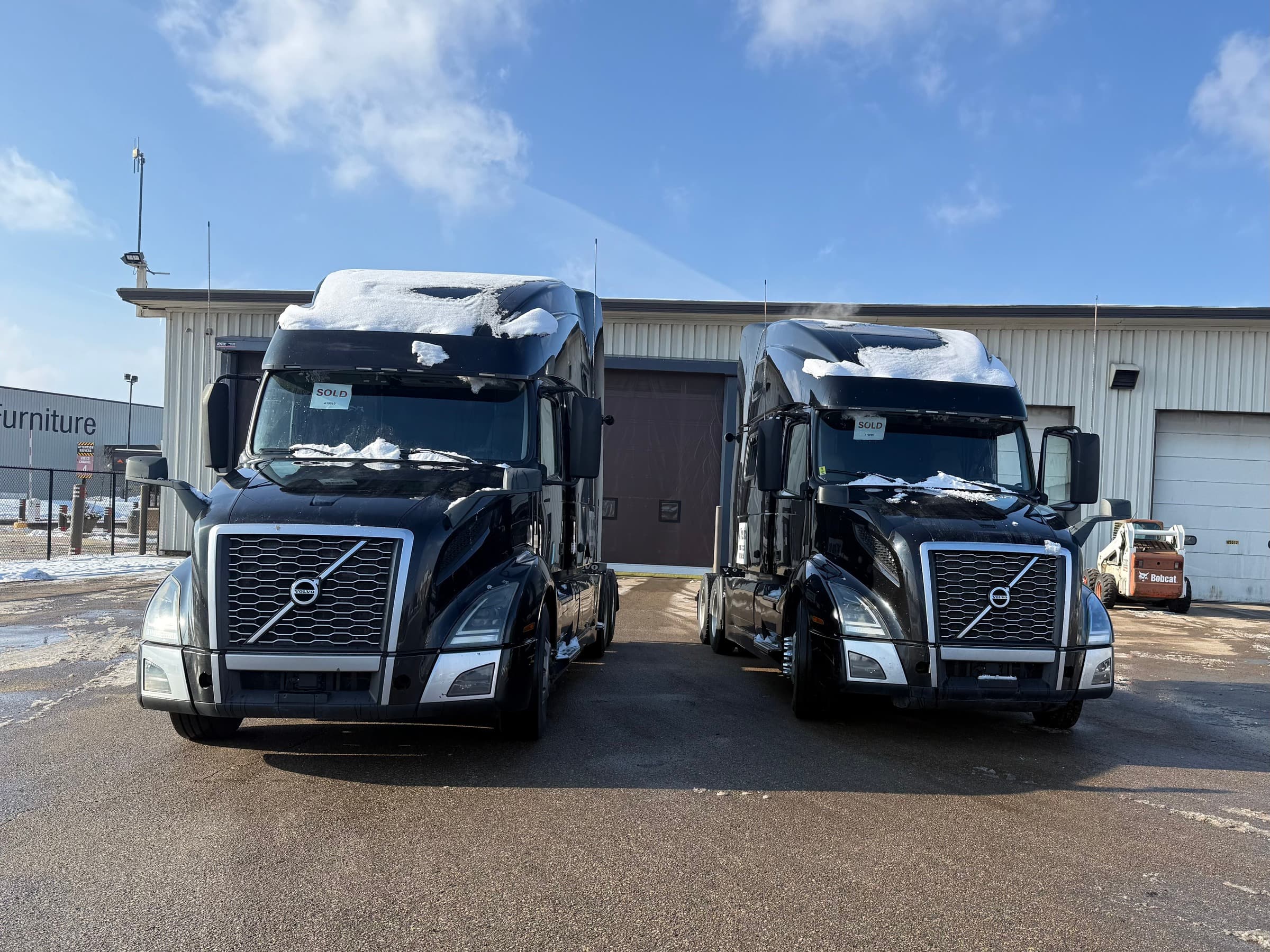 A pair of Volvo semi trucks secured for an OTR Consulting 2-truck program